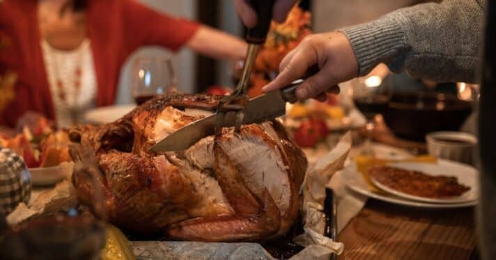 Slicing into a turkey at holiday dinner