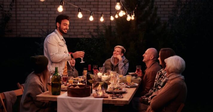 Group of people having dinnner together at night