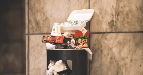 dumpster flooded with junk food garbage