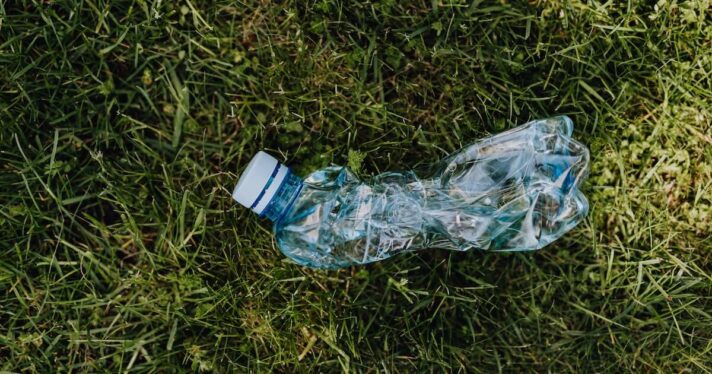 crushed plastic bottle on the grass