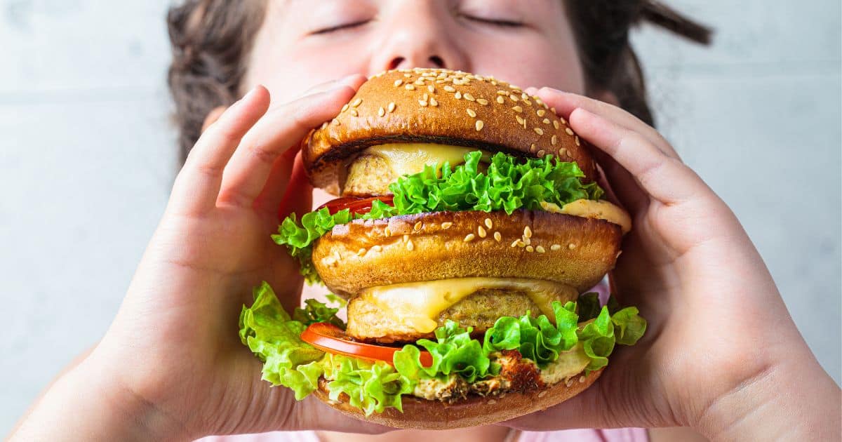 image of kid eating plant-based burger
