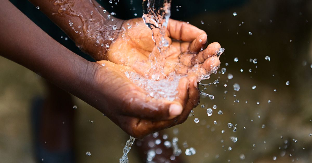 image of child's hands cupped for stream of water, Clean Water Act