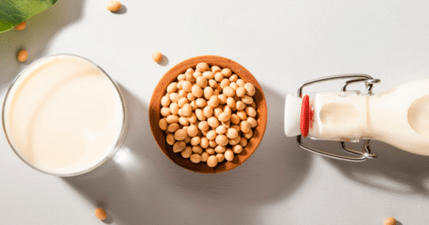 Soy milk and soybeans on table