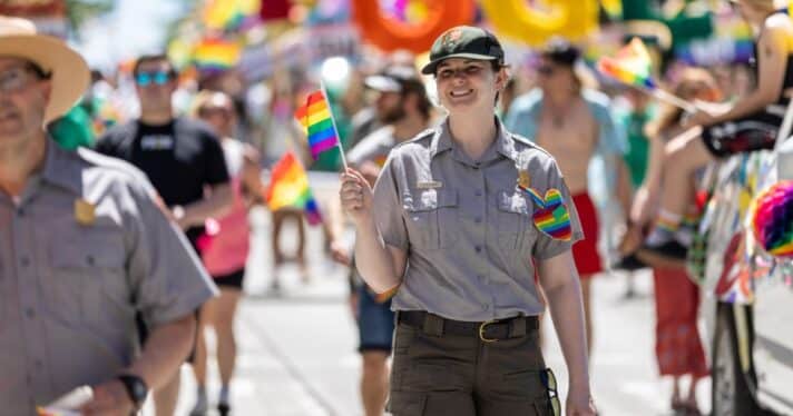 Employees and volunteers from Mount Rainier National Park, Olympic National Park, Klondike Gold Rush National Historical Park, the NPS Seattle Support Office, and Olympic National Forest walk in the Seattle Pride Parade on Sunday June 27, 2022.