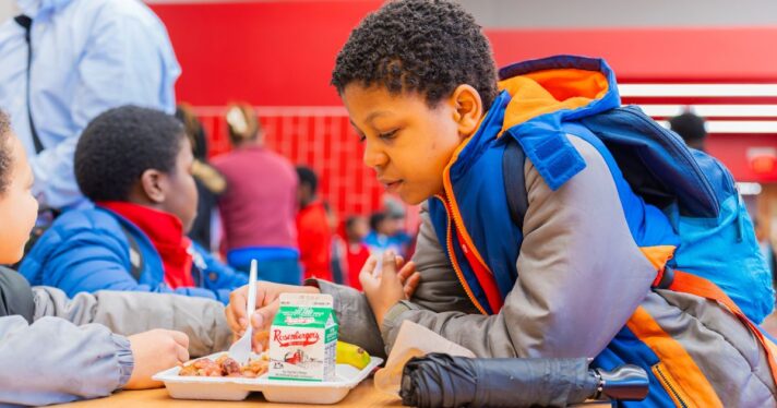 Students have a lunch tray with a small carton of milk