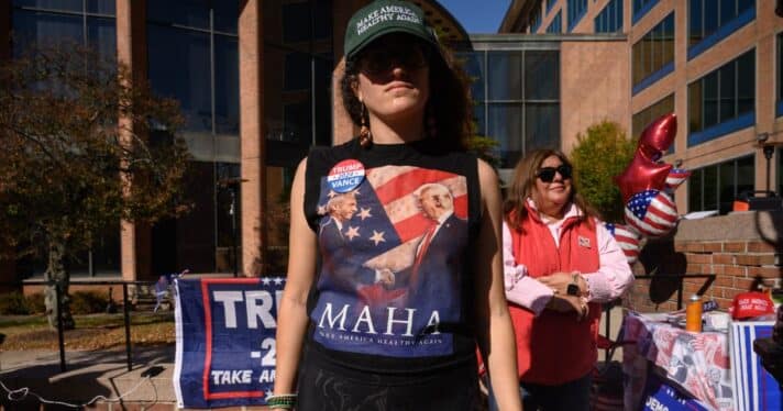 A Donald Trump supporter wears a hat that says 