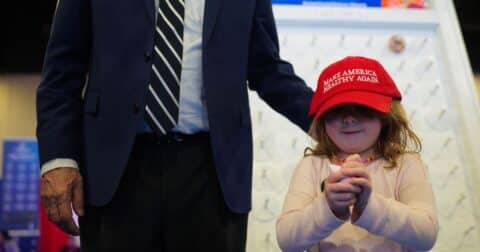 Child in a red Make America Healthy Again hat at CPAC