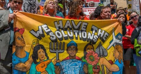 Climate protesters holding up a banner that says 