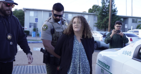 A young woman being arrested
