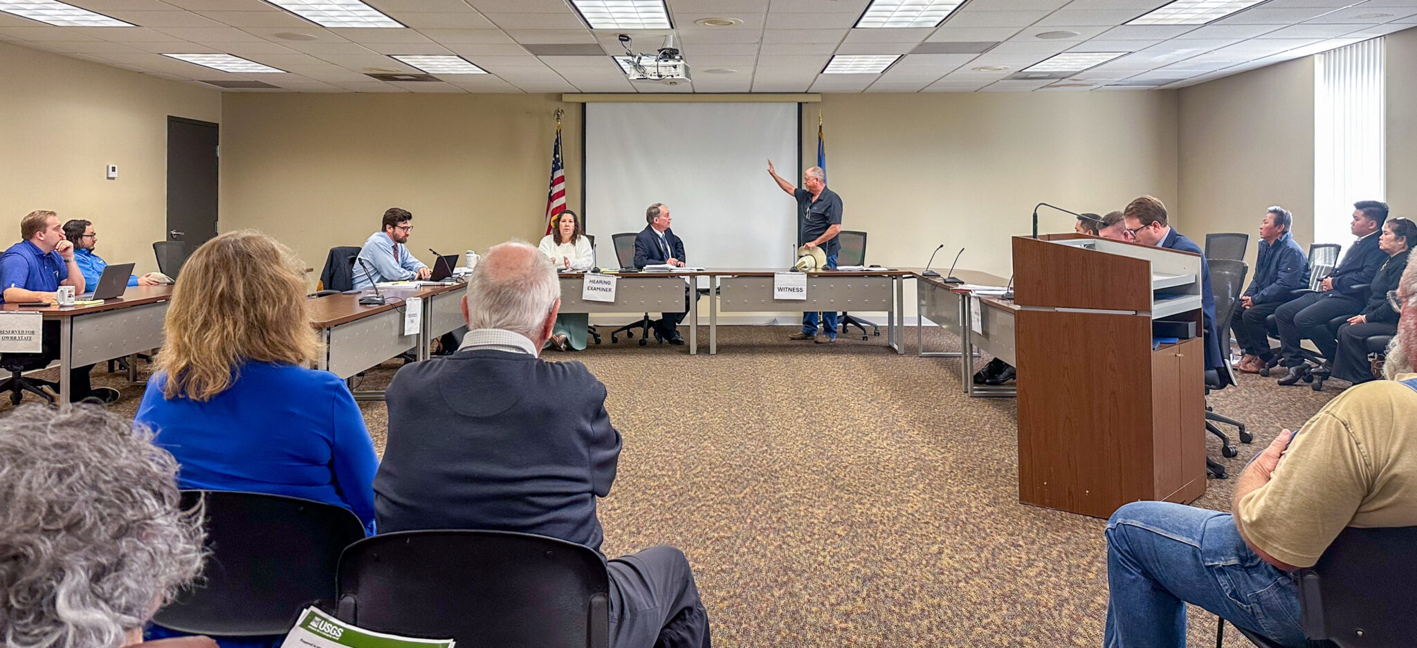 People sitting in chairs at a meeting