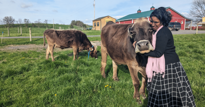 A woman hugging a cow