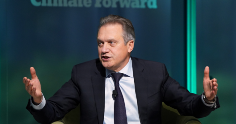 A man in a suit sitting and talking