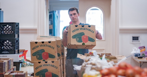 A young person organizing boxes of food