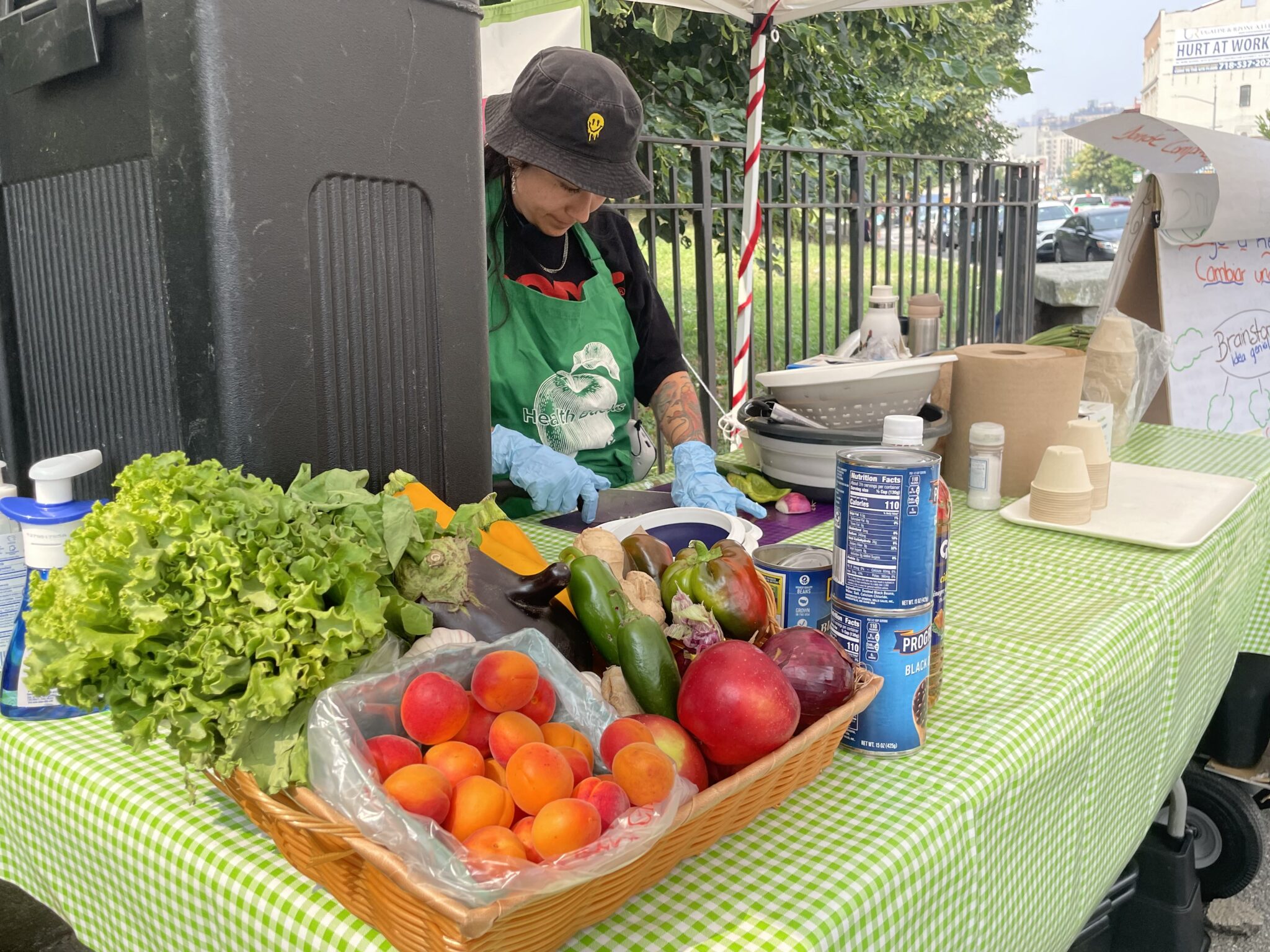 A person cutting vegetables at a stand