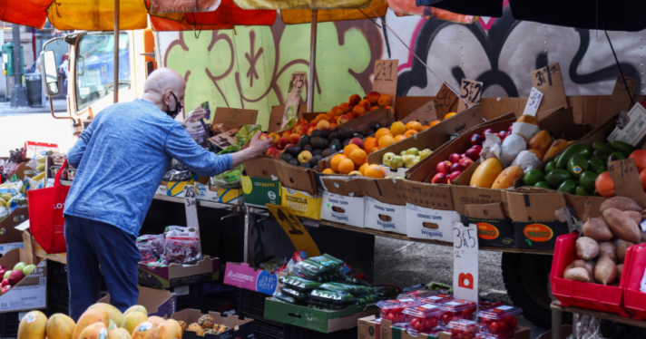 A man shops at a grocery stand