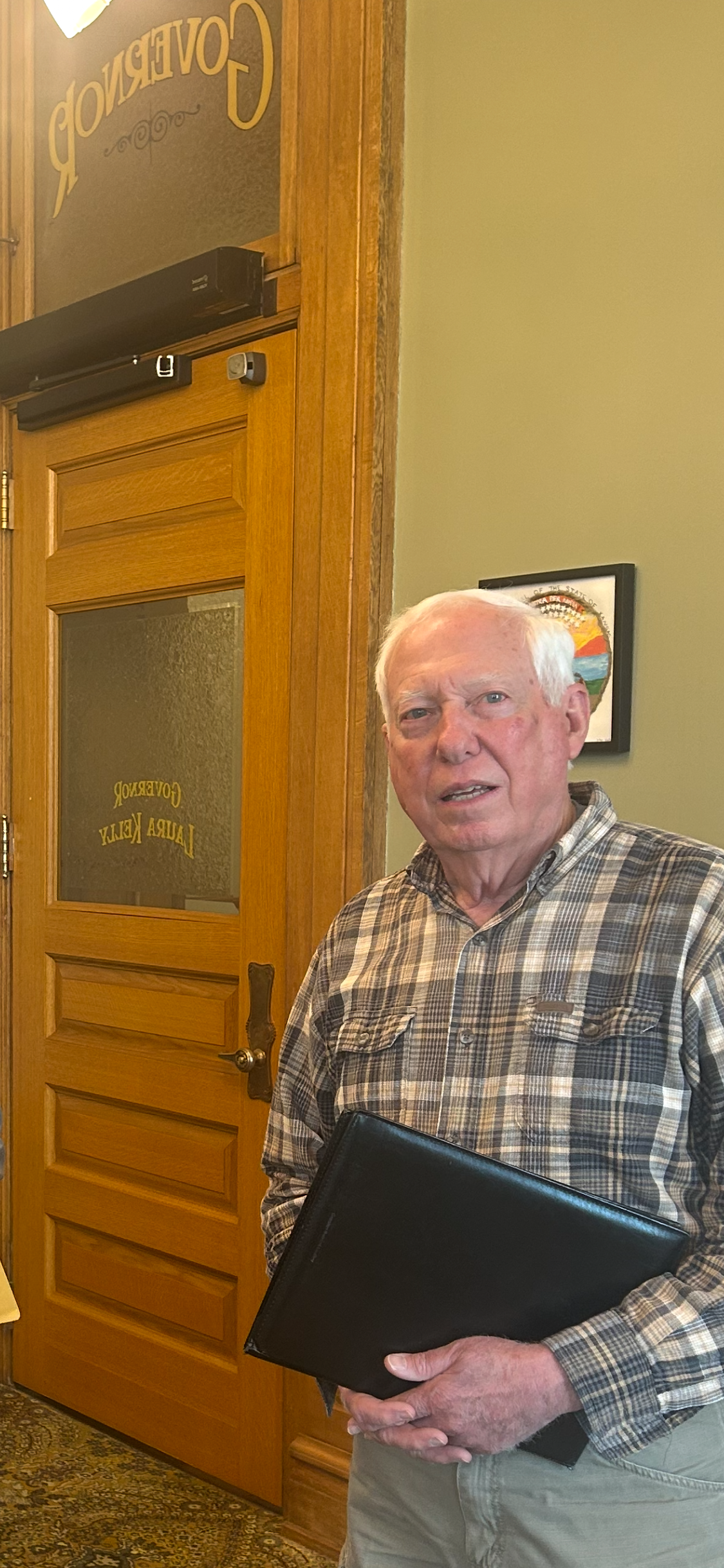 A man standing outside an office door
