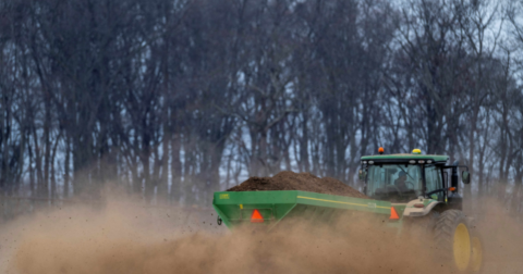 A tractor laying fertilizer