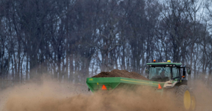 A tractor laying fertilizer