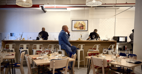 A man sitting on a restaurant bar stool