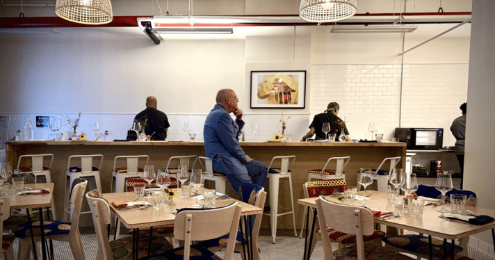 A man sitting on a restaurant bar stool