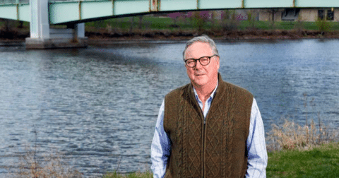 A man standing in front of a body of water