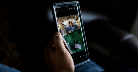 A person holding up a picture on their phone