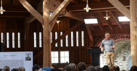 A man speaking on a stage