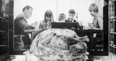 A family sitting down for Thanksgiving dinner