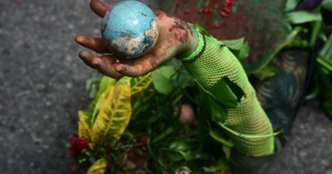 A small globe in an activist's hand