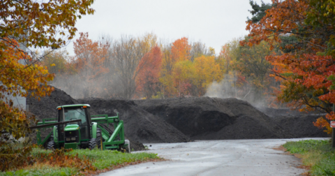 A truck near piles of compost and mulch