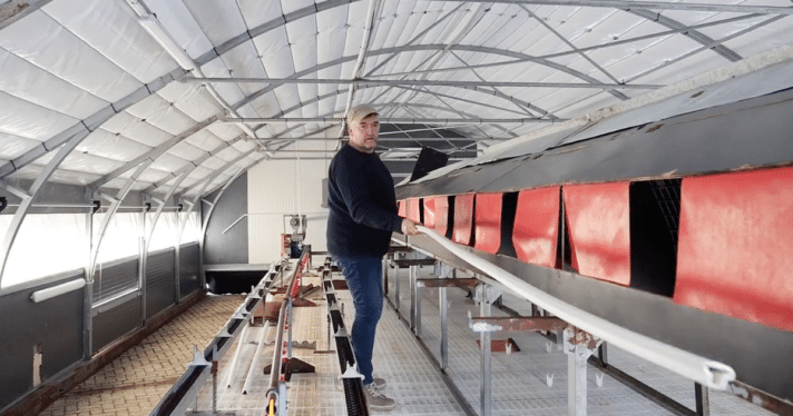 An organic farmer in an empty farm building
