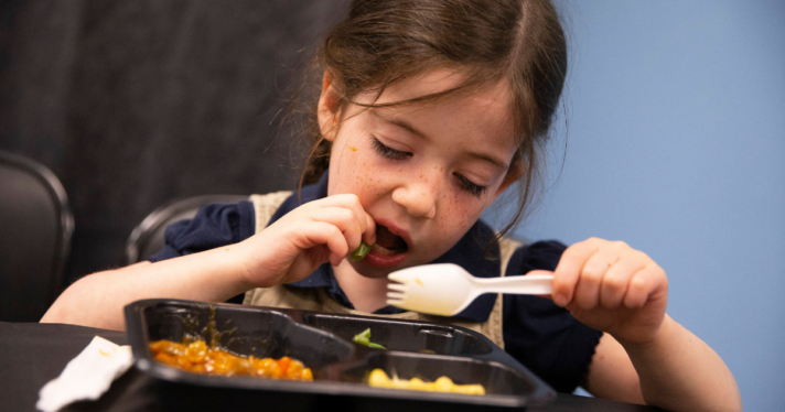 A child eating their school lunch