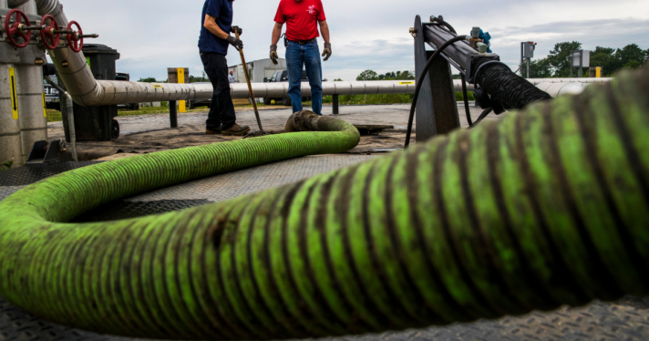 A green tube pumping waste