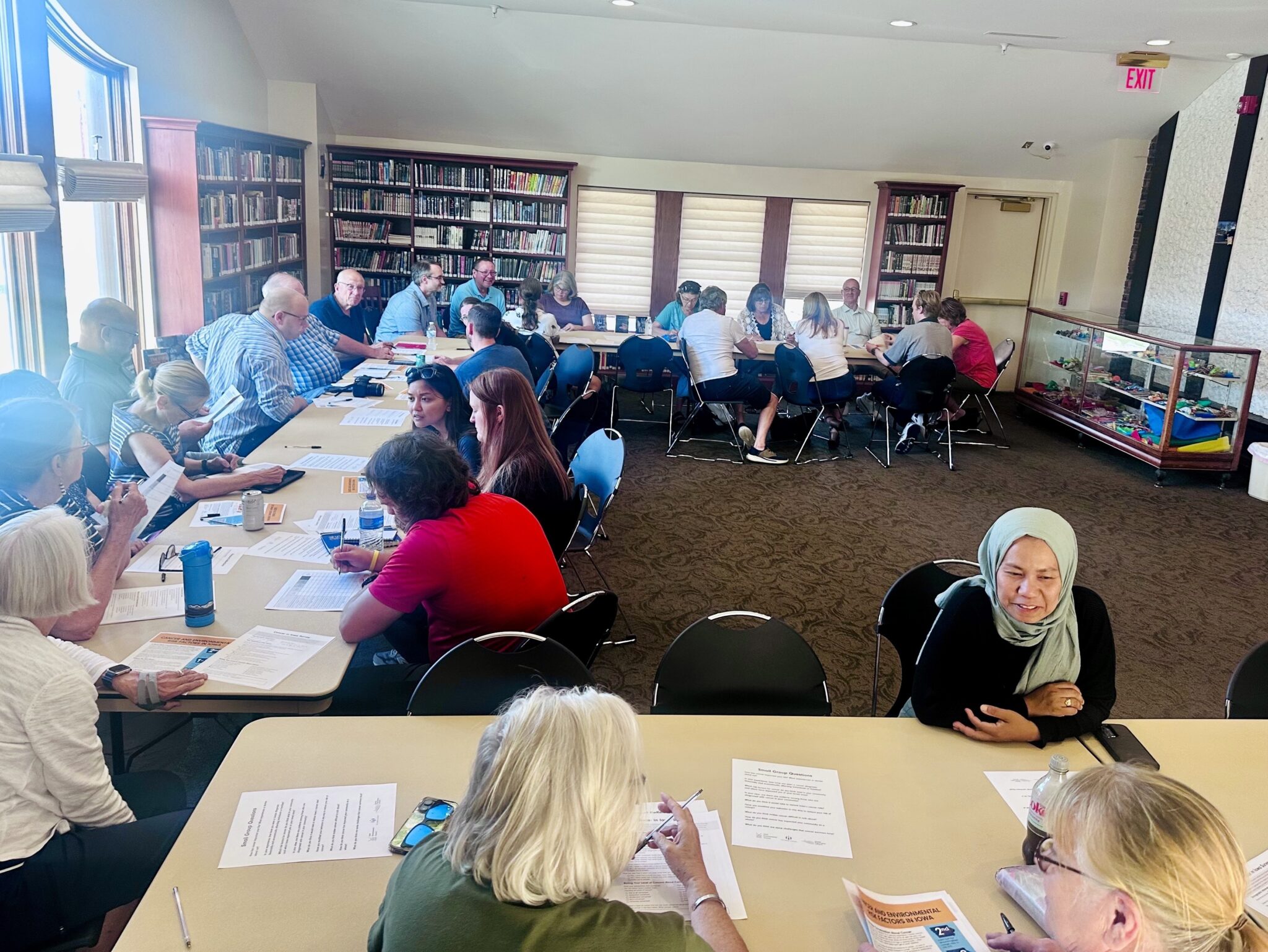 A room with people sitting at various tables
