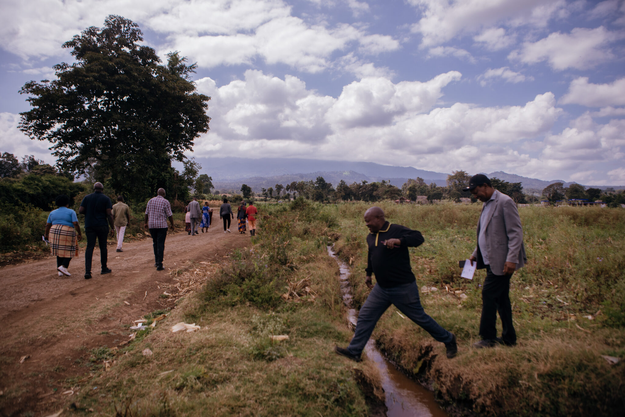 A man leaping over a small trail of water