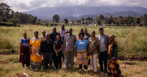 A group of people standing together on grass