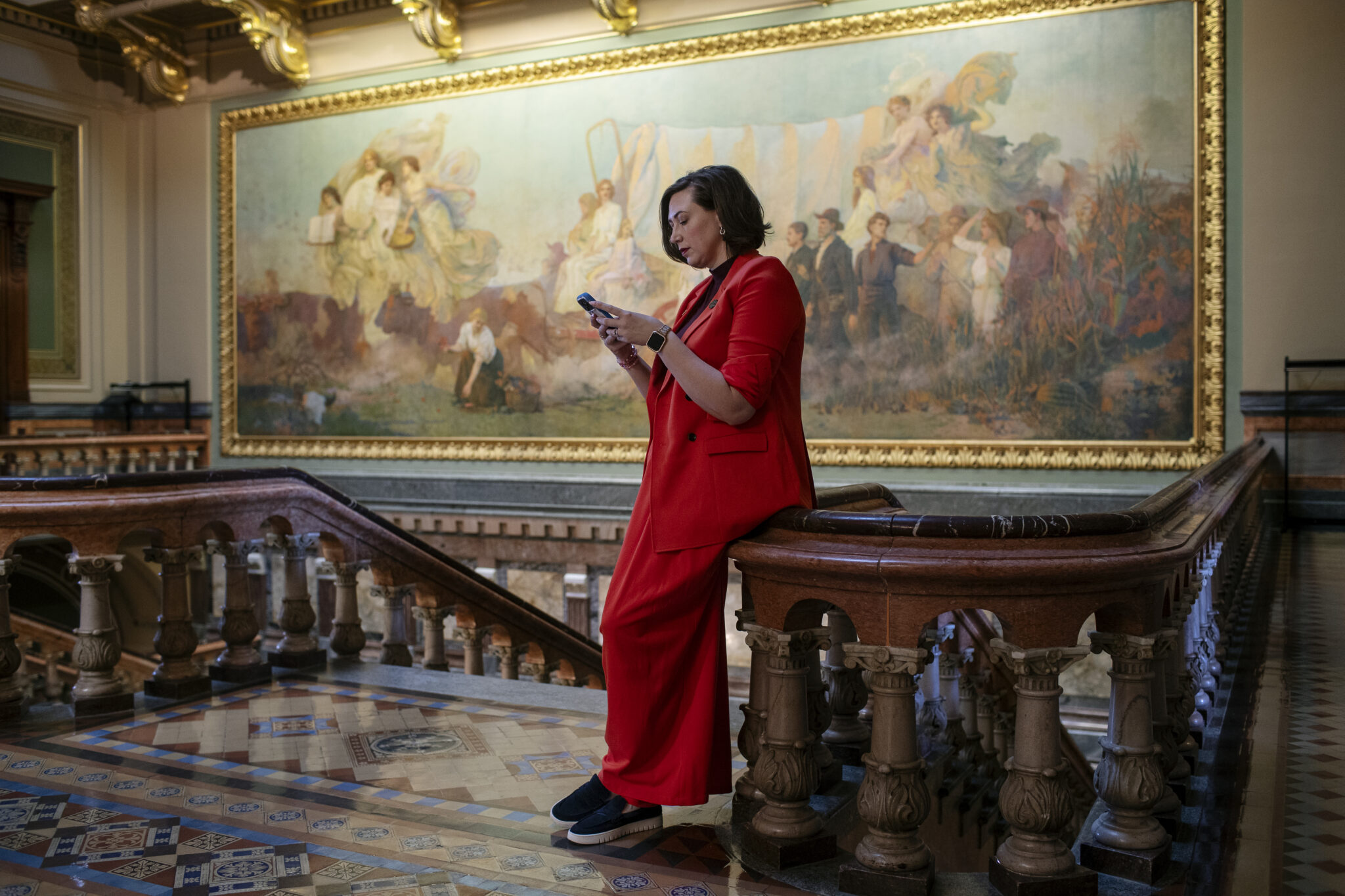 Iowa State Senator Catelin Drey on her phone