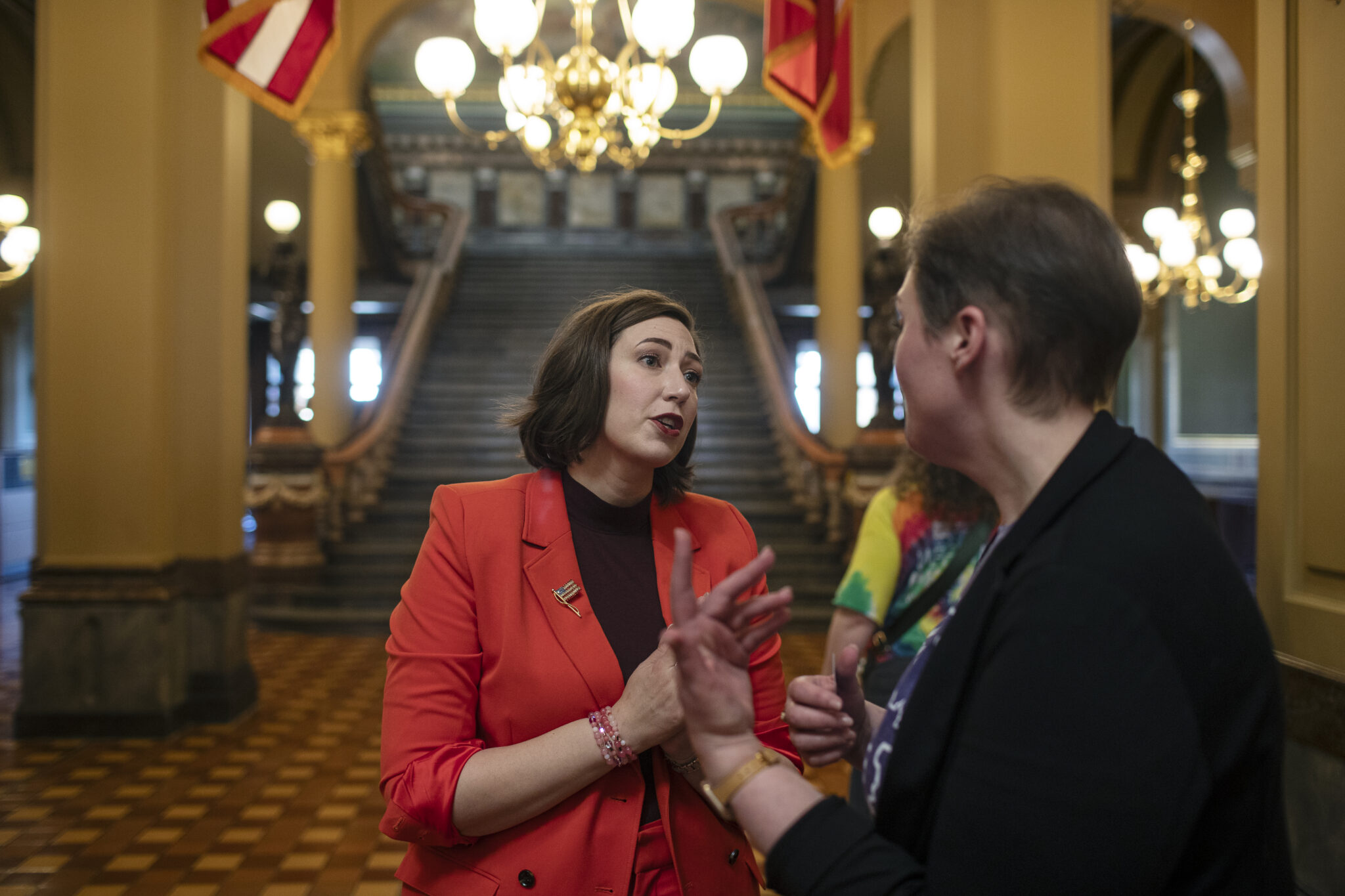 Iowa State Senator Catelin Drey speaking to another person