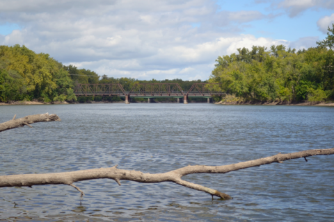 A river with a bridge over it in the distance