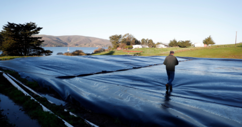 A man walking across a methane digester