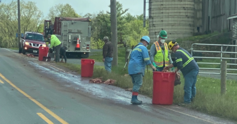 A crew cleaning up the road