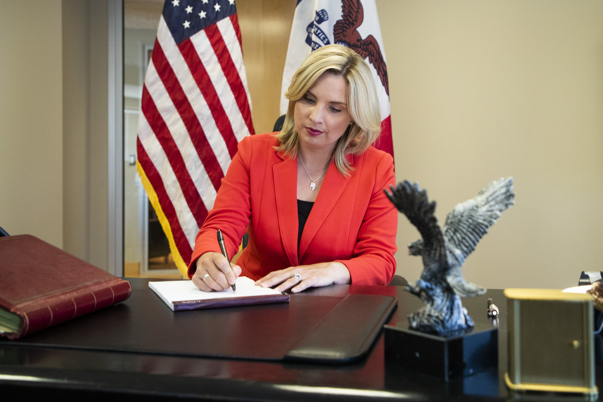 A Congresswoman writing at her desk