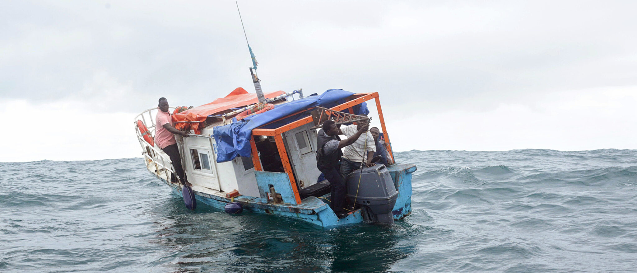 A group of people in a small boat in ocean