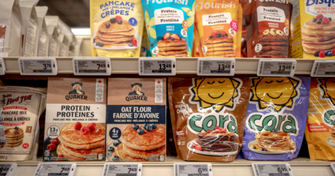 Rows of pancake products on grocery store shelves